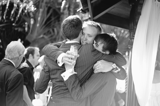 groomsmen hugging groom