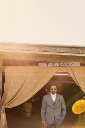 Groom in grey suit with yellow bow tie