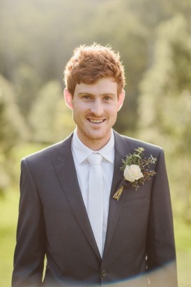 Groom in grey suit with white tie