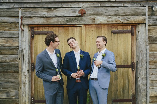 groom and groomsmen with barn