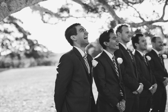 groom laughing as he sees his bride