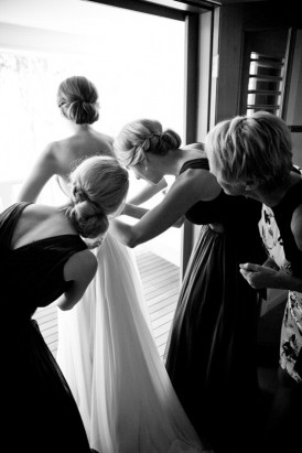 putting putting on wedding dress