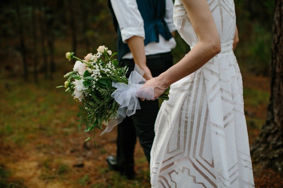 Bride and groom walking in forest