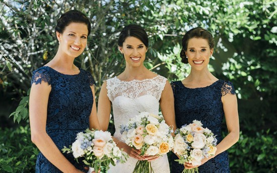 Bridesmaids in navy lace dresses