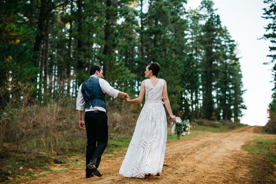 Newlyweds in pine forest