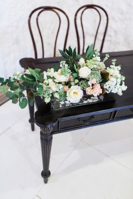 White and green foliage arrangement for ceremony arrangement