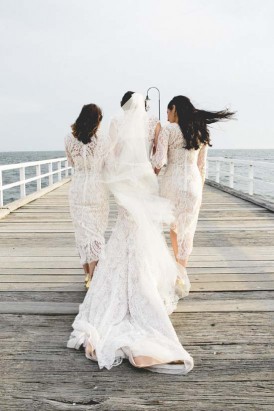 bride and bridesmaids on pier