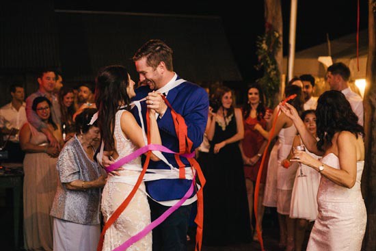 bride and groom wrapped in streamers