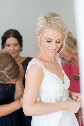 bride putting on dress
