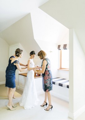 bride putting wedding dress on