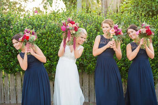 bride with bridesmaids in navy gowns