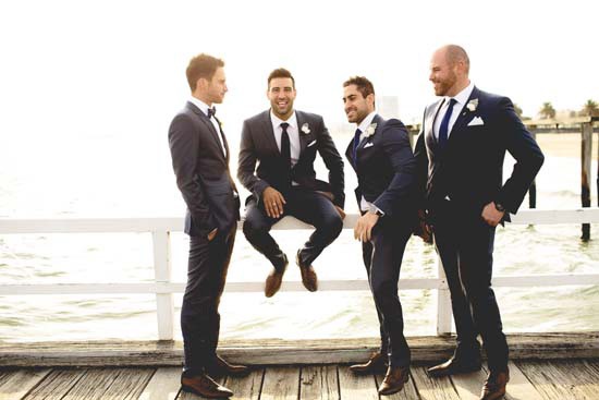 groom and groomsmen on pier