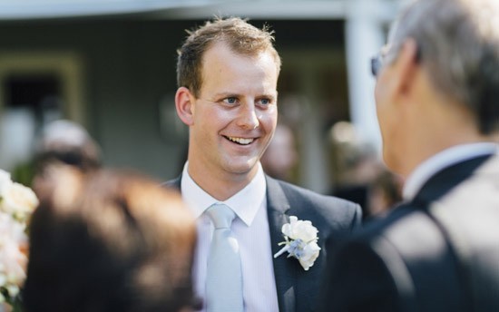 groom in gibson suit with pale blue tie