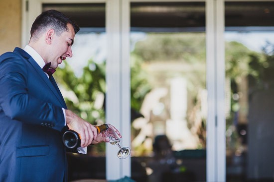 groom pouring champagne