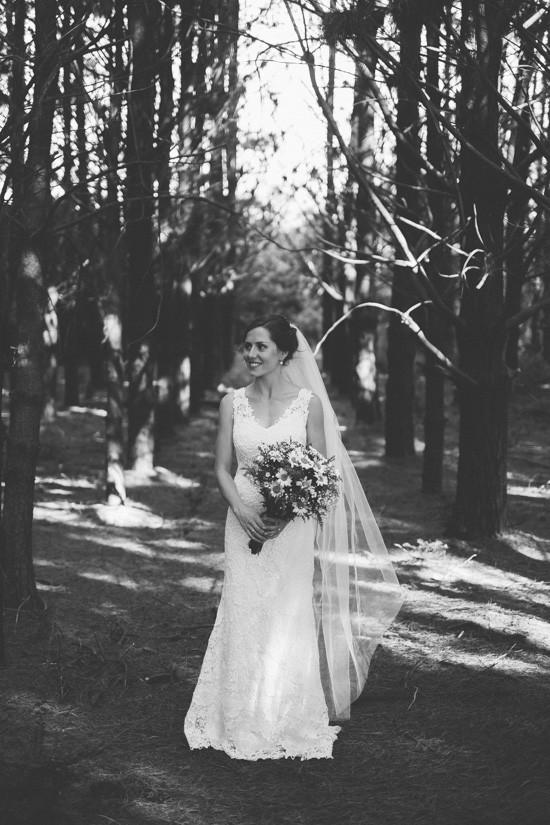 Black and white photo of bride in forest