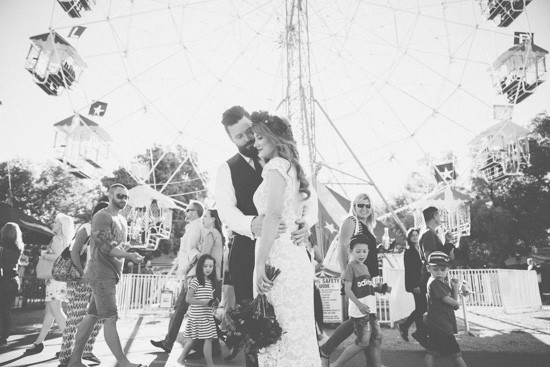 Bride and groom in front of ferris wheel