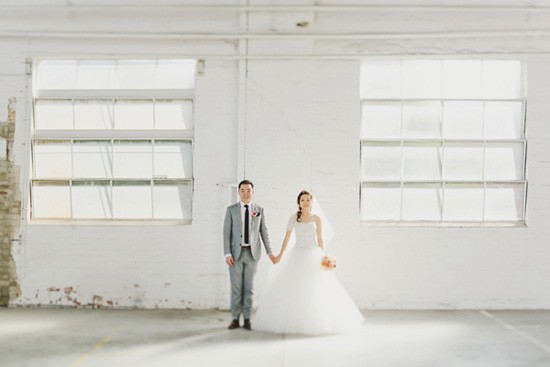 Bride and groom in white industrial space