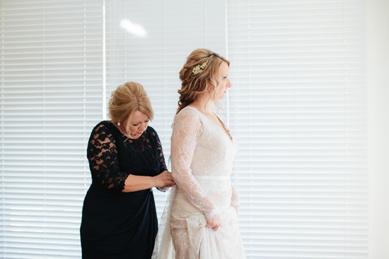 Bride putting gown on