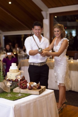Cutting cake with champagne sabre