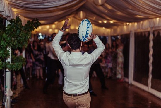 Football toss at wedding
