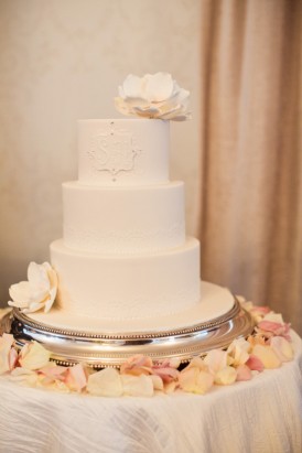 Three tier white wedding cake with sugar flowers