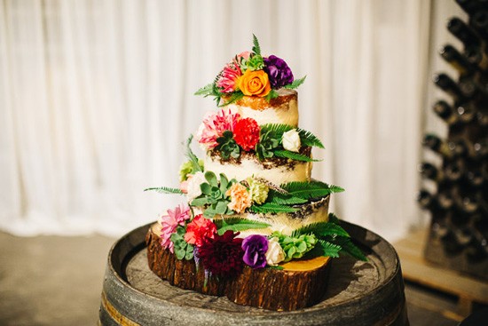 Wedding cake with lots of bright flowers