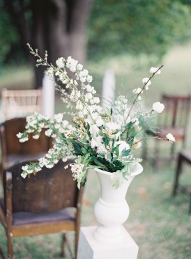 White floral arrangement at outdoor ceremony
