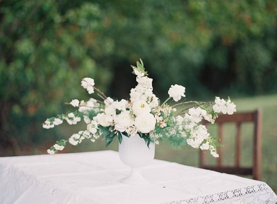 White vase with white flowers at wedding