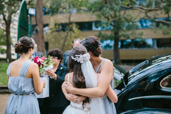 Bride and bridesmaid hugging