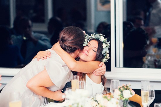 Bride hugging bridesmaid after speech