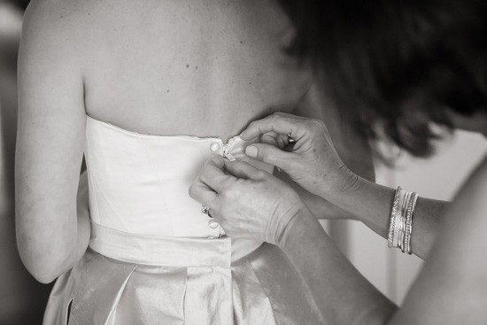 Buttoning up bridal gown
