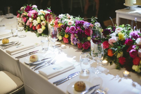 Colourful flowers on wedding head table