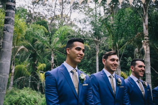 Groom and groomsmen in blue suites with taupe ties