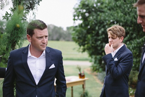 Groom and groomsmen in navy suits with white shirts
