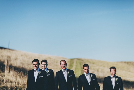 Groom and groomsmen with blue suits and bow ties