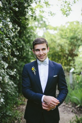 Groom in navy suit with bow tie
