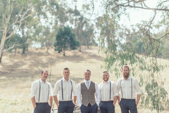 Groom in waistcoat with groomsmen in suspenders