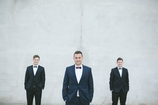 Groom with groomsmen in tuxedos