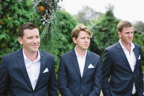 Groomm in navy suit with white shirt