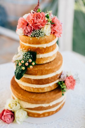 Naked wedding cake with coral flowers