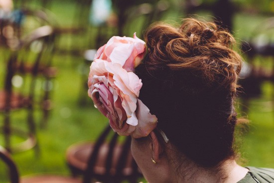 Pink flower in wedding guest hair