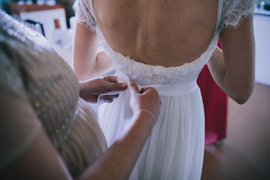 Tying bow on brides dress