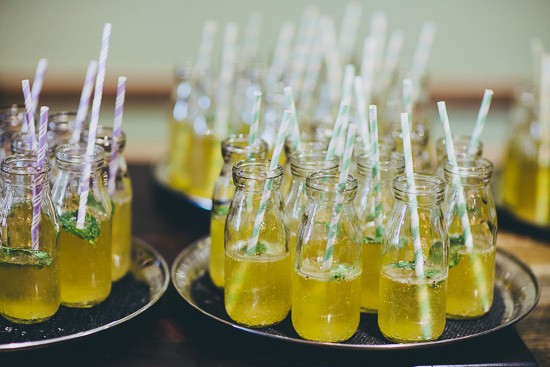 Yellow wedding drinks in glass bottles