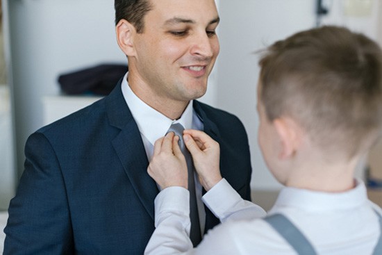 ring bearer doing uo grooms tie
