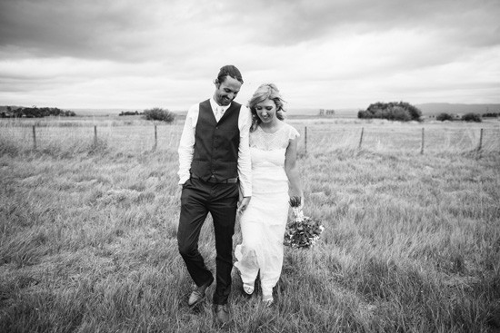 Black and white photo of newlyweds in grass