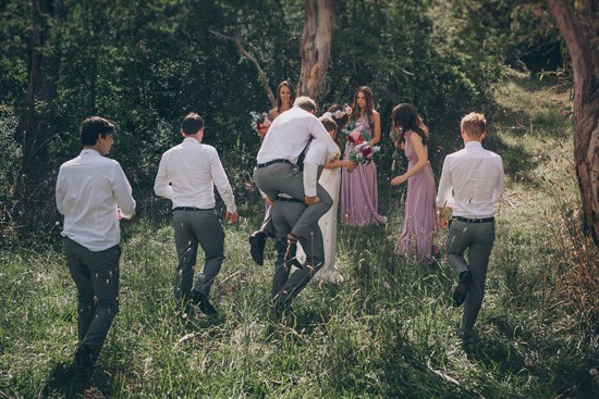 Bridal aprty walking through bush