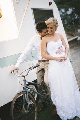 Bride and groom with caravan and bike