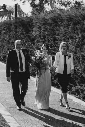 Bride walking with parents
