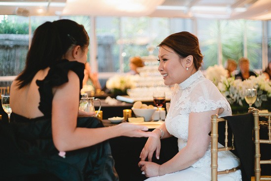 Bride with guest in black dress