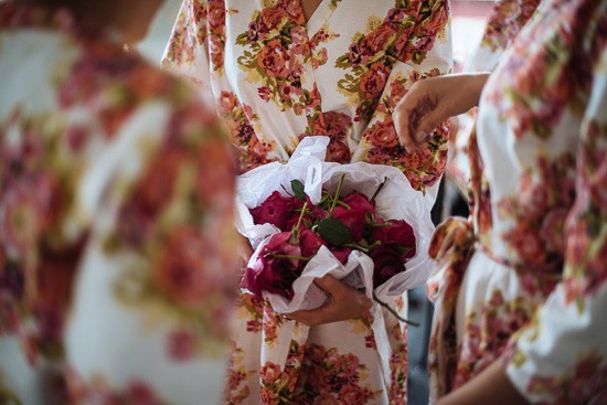 Bridesmaids in printed robes with flowers